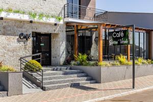 a cafe with stairs in front of a building at Pousada Serra Verde in Cambará