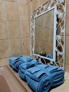 a blue towel sitting on the edge of a bath tub at Horizon Green Guest House in Randfontein