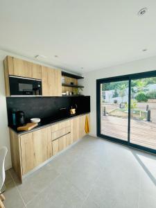 a living room with a large window and a kitchen at La suite provençale in Marseille