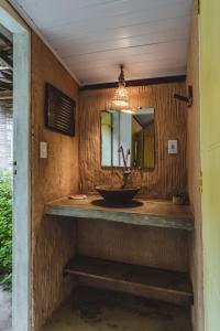 a bathroom with a sink and a mirror at Vila das Ondas Caraíva in Caraíva