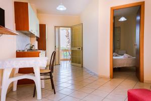a kitchen and living room with a table and chairs at Residence Porto Ulisse in Parghelia