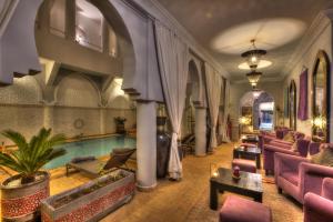 a living room with a pool in a building at Riad Shemsi in Marrakesh