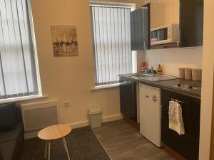 a kitchen with a sink and a counter top at Bv Comfy Budget Studio At Quebec Street Bradford in Bradford