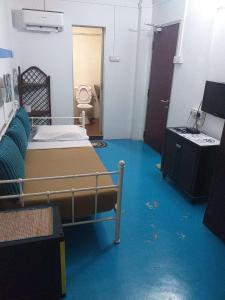 a bedroom with a bed in a room with blue carpet at D Riverside Inn in Malacca