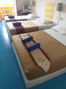 a row of beds lined up in a room at D Riverside Inn in Malacca