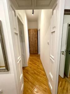 an empty hallway with a door and wooden floors at Luxury Apart Vitosha Boulevard in Sofia