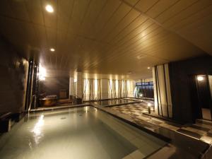 a large swimming pool in a building at Himeji Castle Grandvrio Hotel in Himeji