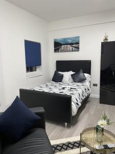 a bedroom with a bed and a couch at BV Lush Studio At Queensgate Huddersfield Town Centre in Huddersfield