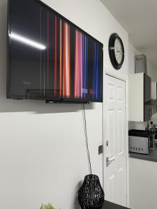 a flat screen tv hanging on a wall in a kitchen at BV Lush Studio At Queensgate Huddersfield Town Centre in Huddersfield