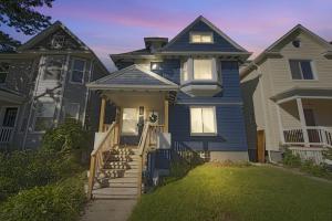 a group of three houses with a blue house at Pet Friendly 5BR Home near Downtown Detroit in Detroit