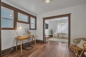 a living room with a desk and a table at Pet Friendly 5BR Home near Downtown Detroit in Detroit