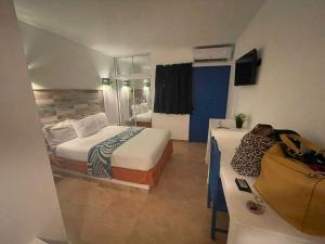 a hotel room with two beds and a television at Nuovo Hotel Playa Catalina in La Romana