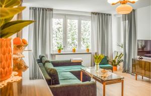 a living room with a couch and a table at Awesome Apartment In Darlowo With Kitchen in Darłowo