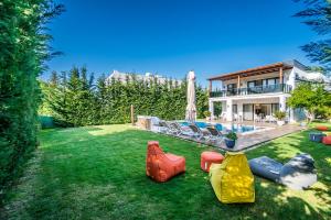 a yard with several inflatable objects on the grass at Contemporary Luxury Villa in Yalıkavak Center in Bodrum City