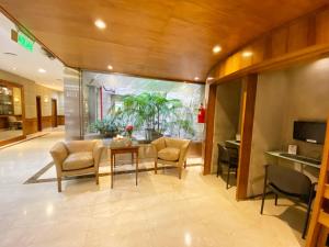 a living room with a table and chairs at Lafayette Hotel in Buenos Aires