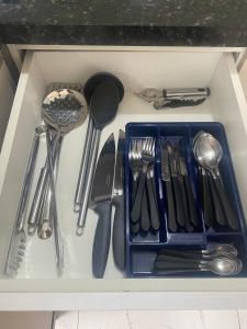 a drawer filled with utensils in a kitchen at Ap aconchegante no centro de Joinville com vaga in Joinville