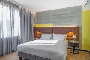 Ένα ή περισσότερα κρεβάτια σε δωμάτιο στο Pullman Santiago El Bosque