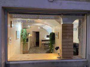 a store window with a sign that reads procurement outpatientulture at Espace Le Cheval Blanc in Castelnau-le-Lez
