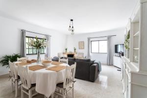a dining room and living room with a table and chairs at Monte Madalena in Adega