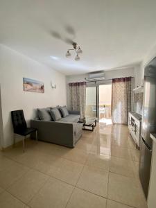 a living room with a couch and a table at APARTAMENTO EN LOS CRISTIANOS - FREE WIFI in Los Cristianos
