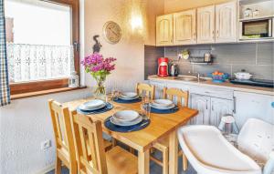 a kitchen with a wooden table with chairs and a sink at Lovely Apartment In Bobolin With Kitchen in Bobolin