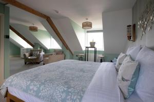 a bedroom with a large bed in a attic at The Beach Club in Penzance