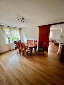 a dining room with a table and chairs at Pensjonat Sabina in Koszarawa