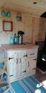 a kitchen with a wooden counter top in a cabin at Sapphire forest garden shepherd’s hut in Church Stretton