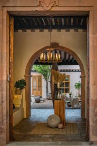 an open door to a patio with a chandelier at La Valise San Miguel de Allende in San Miguel de Allende