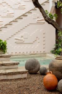 a swimming pool with some rocks and stairs at La Valise San Miguel de Allende in San Miguel de Allende