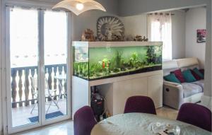 a living room with a fish tank in the corner at Amazing Apartment In Publier With Internet And 1 Bedrooms in Publier