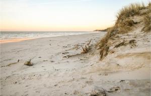 a sandy beach with footprints in the sand at Beautiful Home In Wicko With Wifi in Wicko +20 photos