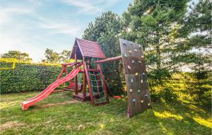 a playground with a slide and a rock wall at Beautiful Home In Wicko With 4 Bedrooms And Wifi in Wicko