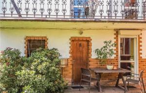 a table and chairs in front of a house at Beautiful Home In Darlowo With 3 Bedrooms in Darłowo