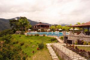 a resort with a swimming pool and a house at Hostería Castillo Real in Zamora