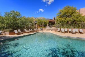 a large swimming pool with chairs at Canyon View #1203 in Tucson