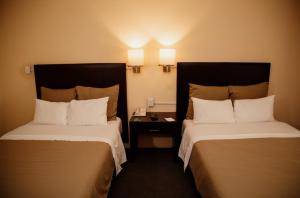 Postel nebo postele na pokoji v ubytování Hotel Rocaval San Cristóbal de las Casas