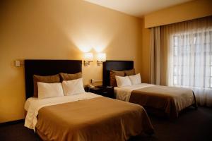 Postel nebo postele na pokoji v ubytování Hotel Rocaval San Cristóbal de las Casas