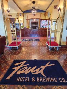 a hotel room with two luggage carts on a floor at The Faust Hotel in New Braunfels