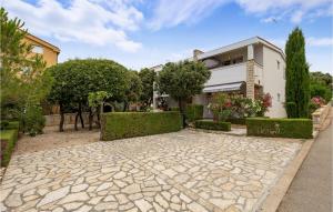 a stone walkway in front of a house at Stunning Apartment In Mandre With Wifi in Mandre
