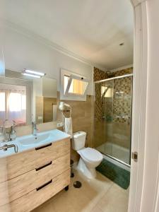 a bathroom with a toilet and a sink and a shower at APARTAMENTO EN LOS CRISTIANOS - FREE WIFI in Los Cristianos