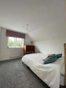 a bedroom with a bed and a window at Sea Breeze Cottage Swanage Bay in Swanage