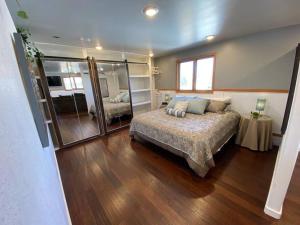 a large bedroom with a bed and a mirror at Roof-top stay, king-size bed, views of Loveland in Loveland