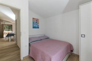 a bedroom with a bed and a dining room at Holiday Home Prapatna 17608 in Pučišća