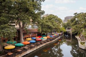 a row of colorful umbrellas on a canal at Sonder The Atlee in San Antonio