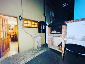 a kitchen with a sink and a brick oven at Cabañas Playa del Sol in San Clemente del Tuyú