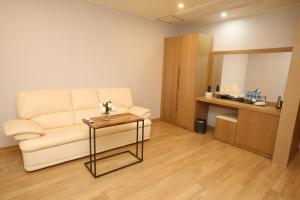 a living room with a couch and a table at Daedunsan Hotel in Wanju