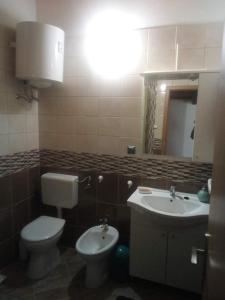 a bathroom with a toilet and a sink at Apartment Silba 17603b in Silba