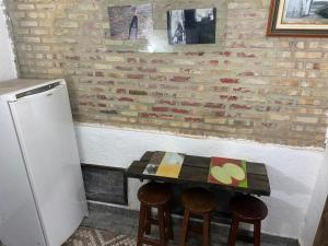 uma cozinha com uma pequena mesa com cadeiras e um frigorífico em Rio Natureza apart 120 no Rio de Janeiro