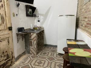 a small kitchen with a sink and a refrigerator at Rio Natureza apart 120 in Rio de Janeiro